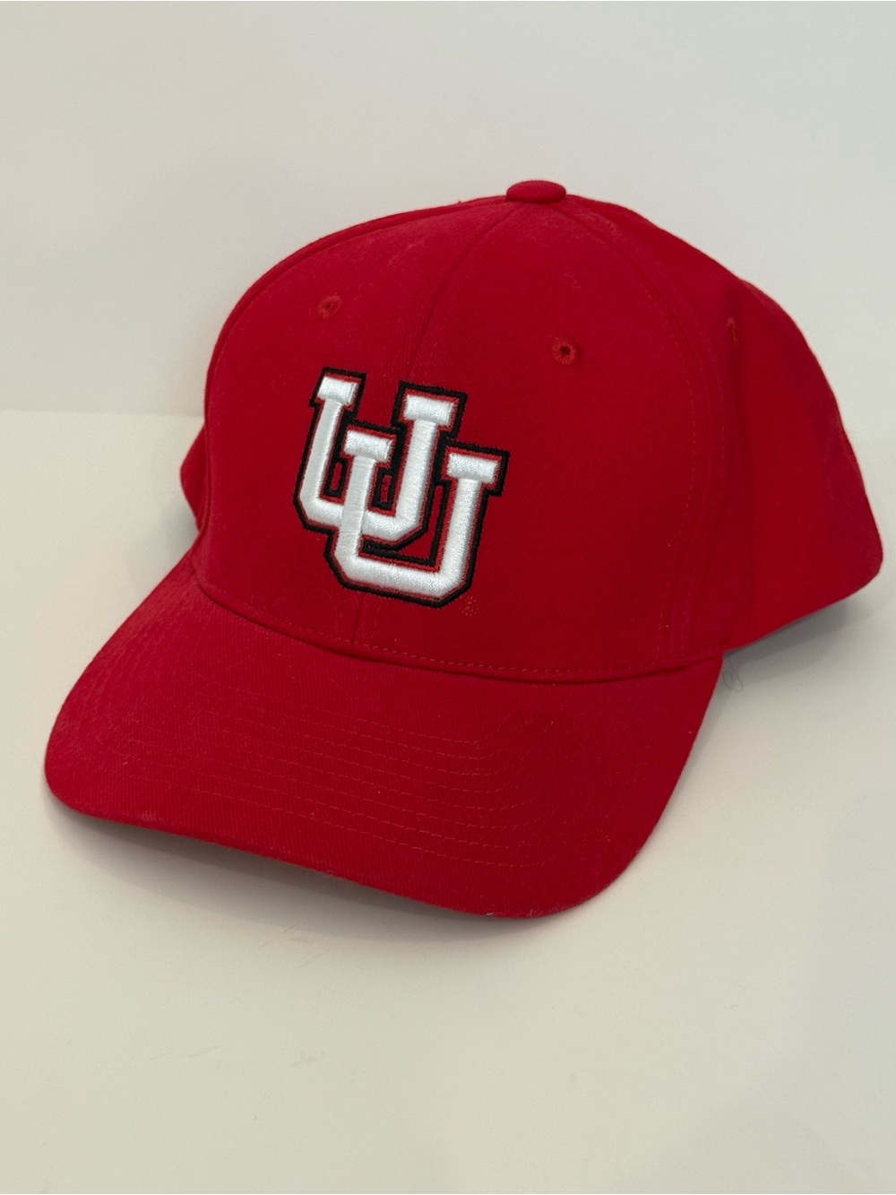 Red and white Embroidered University of Utah Hat. Velcro back.